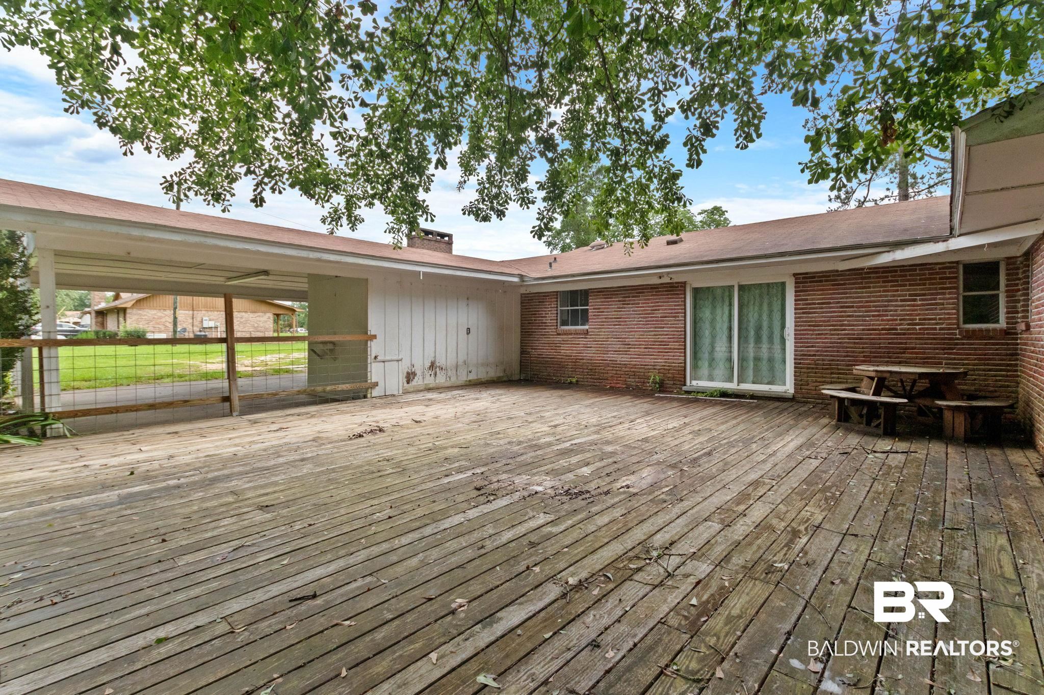 384 Old Bratt Road Atmore, AL 36502 - Photo 62 of 64 Expansive wood deck with a partial overhead cover