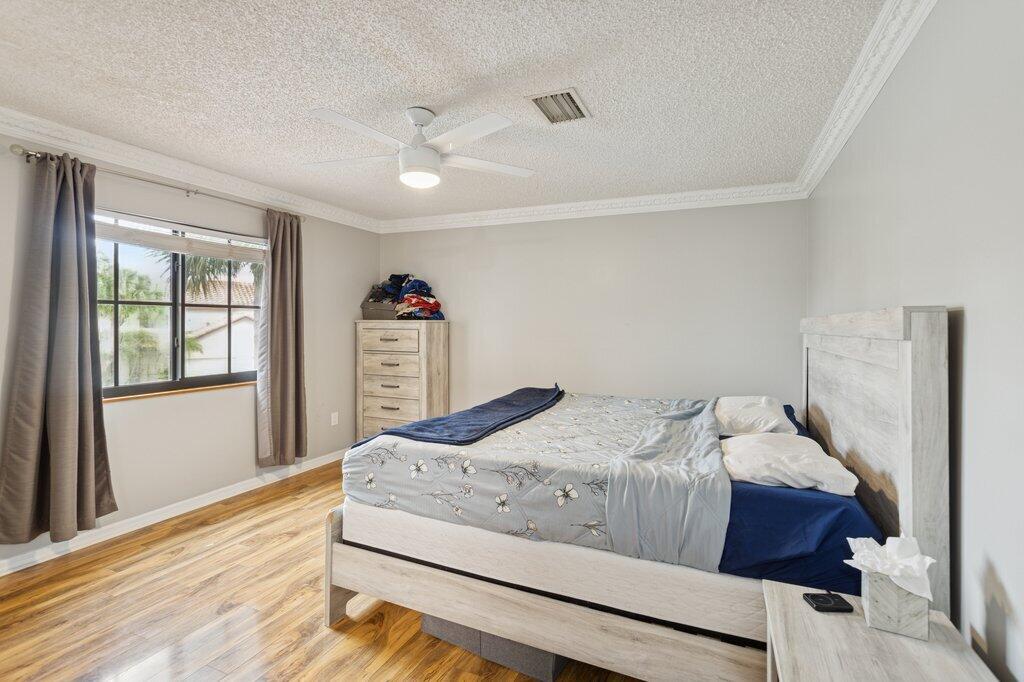 10272 Hidden Springs Court Boca Raton, FL 33498 - Photo 14 of 25 a bedroom with a bed and a window