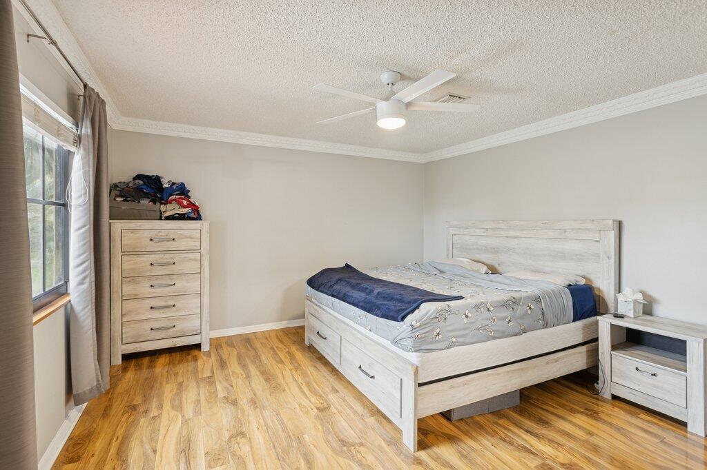 10272 Hidden Springs Court Boca Raton, FL 33498 - Photo 16 of 25 a bedroom with a bed and a dresser