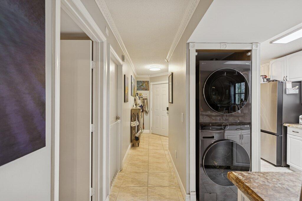 10272 Hidden Springs Court Boca Raton, FL 33498 - Photo 6 of 25 a view of a hallway with a washer and dryer