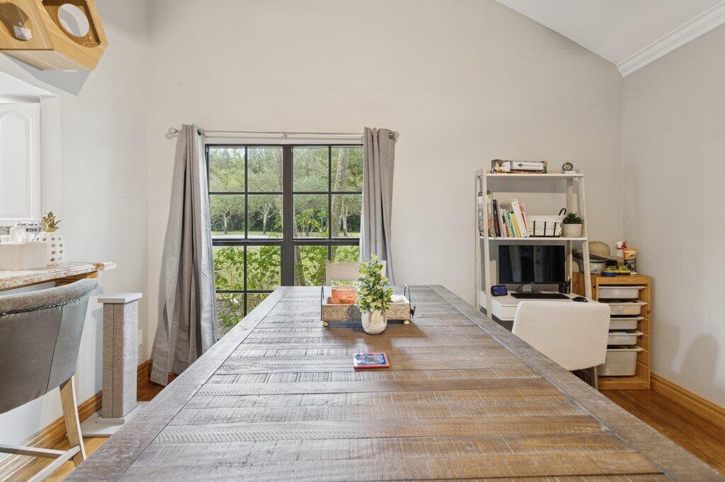10272 Hidden Springs Court Boca Raton, FL 33498 - Photo 8 of 25 a dining room with wooden floor and white walls