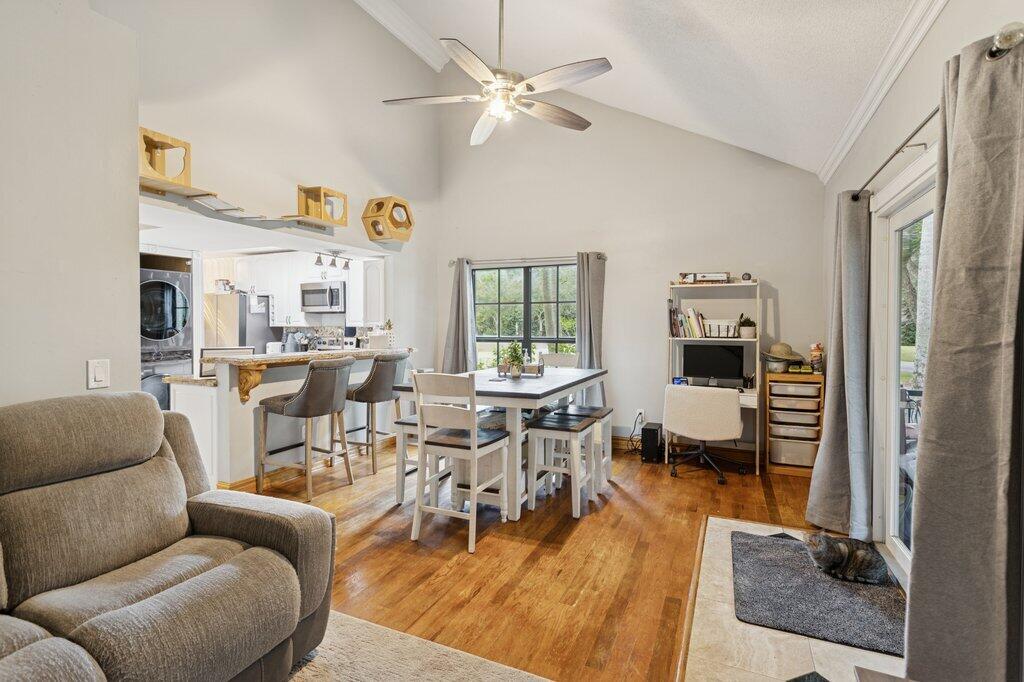 10272 Hidden Springs Court Boca Raton, FL 33498 - Photo 9 of 25 a living room with furniture dining table and a window