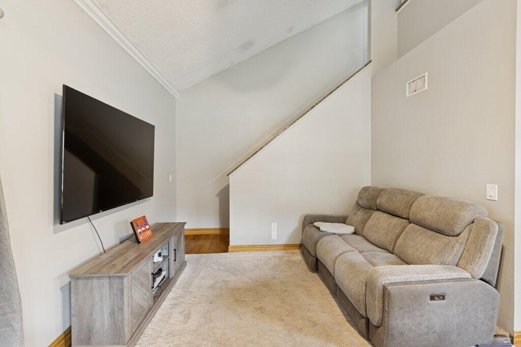 10272 Hidden Springs Court Boca Raton, FL 33498 - Photo 10 of 25 a living room with a flat screen tv a couch and a flat screen tv