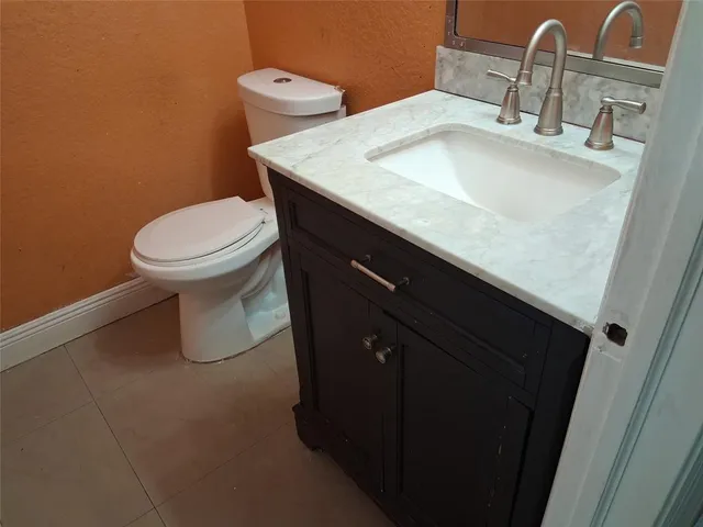 a kitchen with granite countertop a sink stove and refrigerator