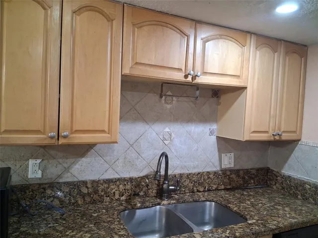 a stove top oven sitting inside of a kitchen