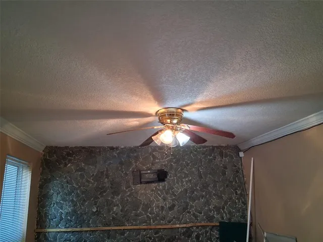 a bathroom with a chandelier fan and a shower