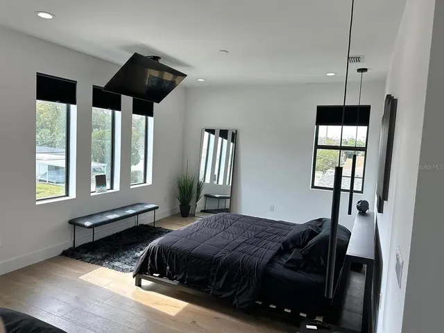 a spacious bedroom with a bed and a window