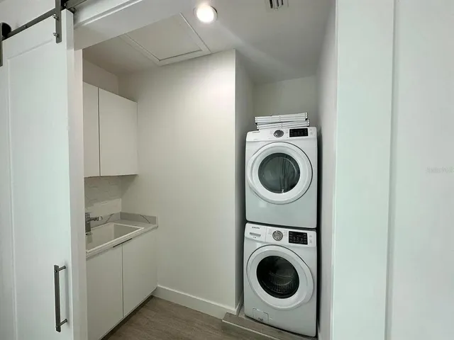 a utility room with sink dryer and washer