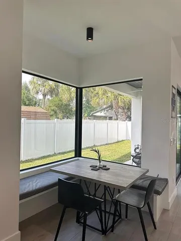 a view of a dining room with a table and chairs