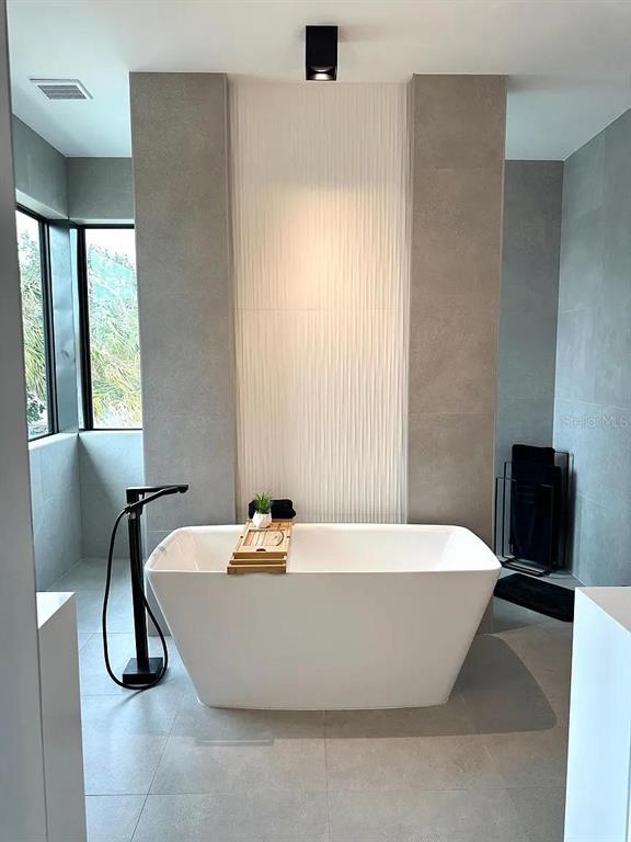 4217 West Arch Street Tampa, FL 33607 - Photo 6 of 22 a white bath tub sitting in a bathroom