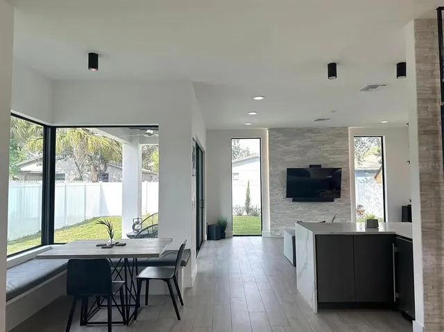 a view of a livingroom with kitchen and furniture