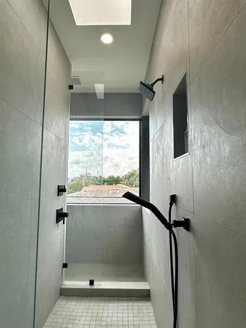 a bathroom with a shower and a tub