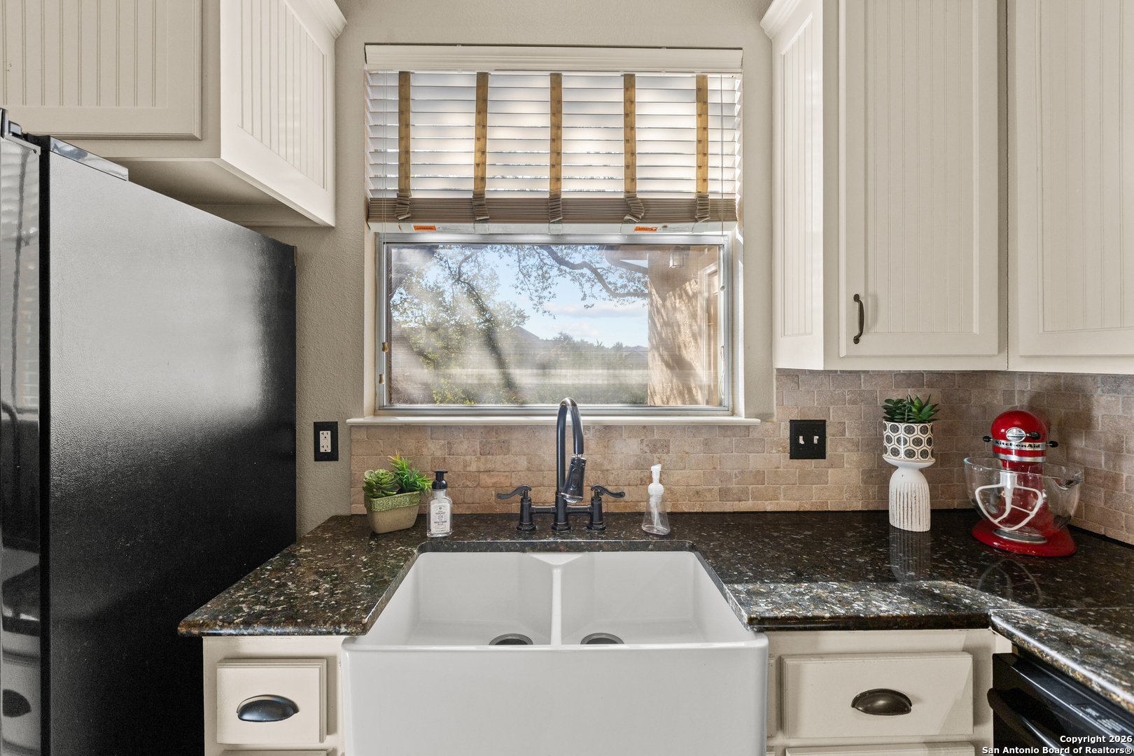250 Misty Brook Spring Branch, TX 78070 - Photo 13 of 47 a kitchen with granite countertop a sink stainless steel appliances and cabinets