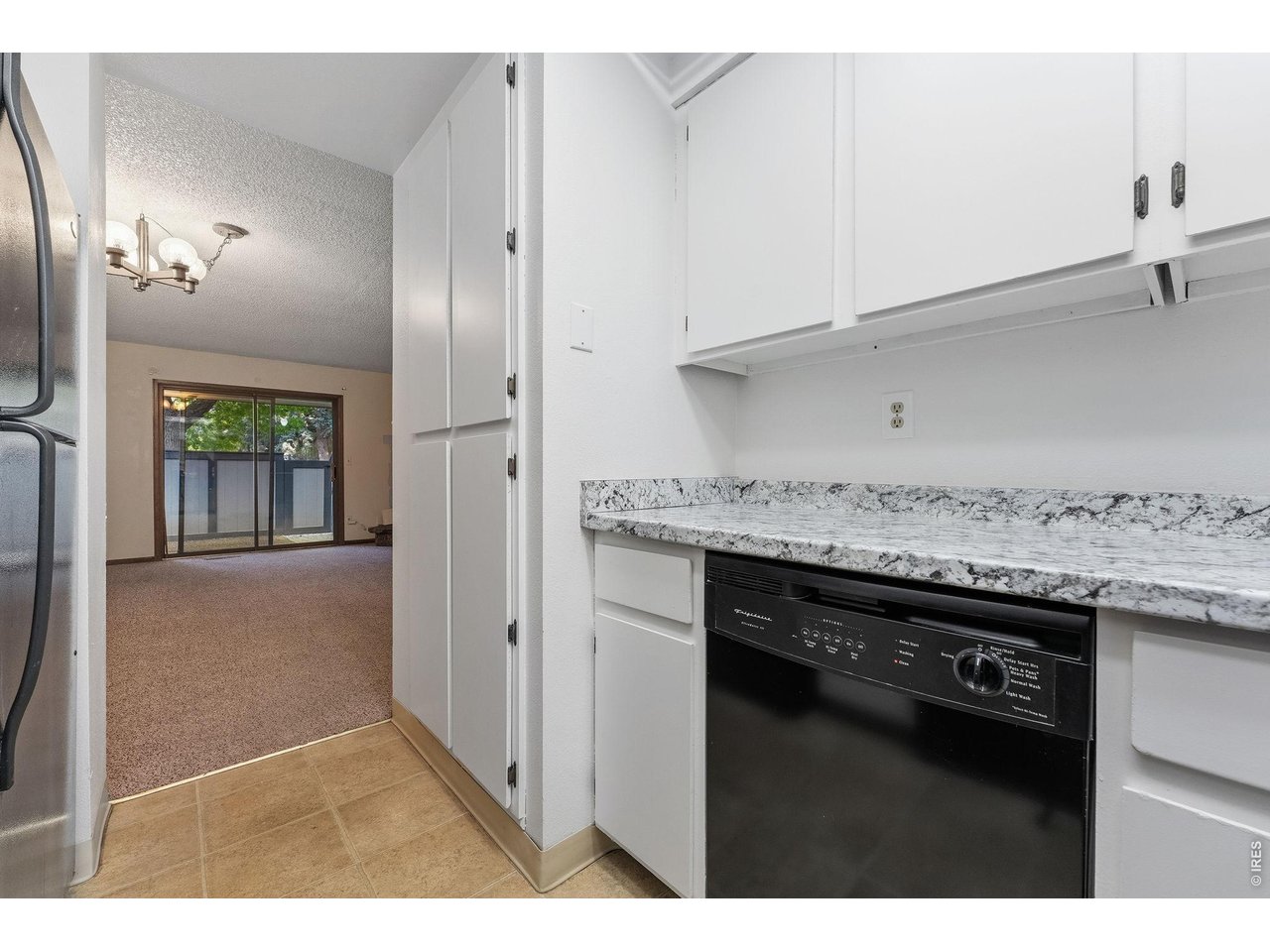 1325 Birch Street, Unit 12 Fort Collins, CO 80521 - Photo 16 of 26 a kitchen with granite countertop a sink cabinets and a wooden floor