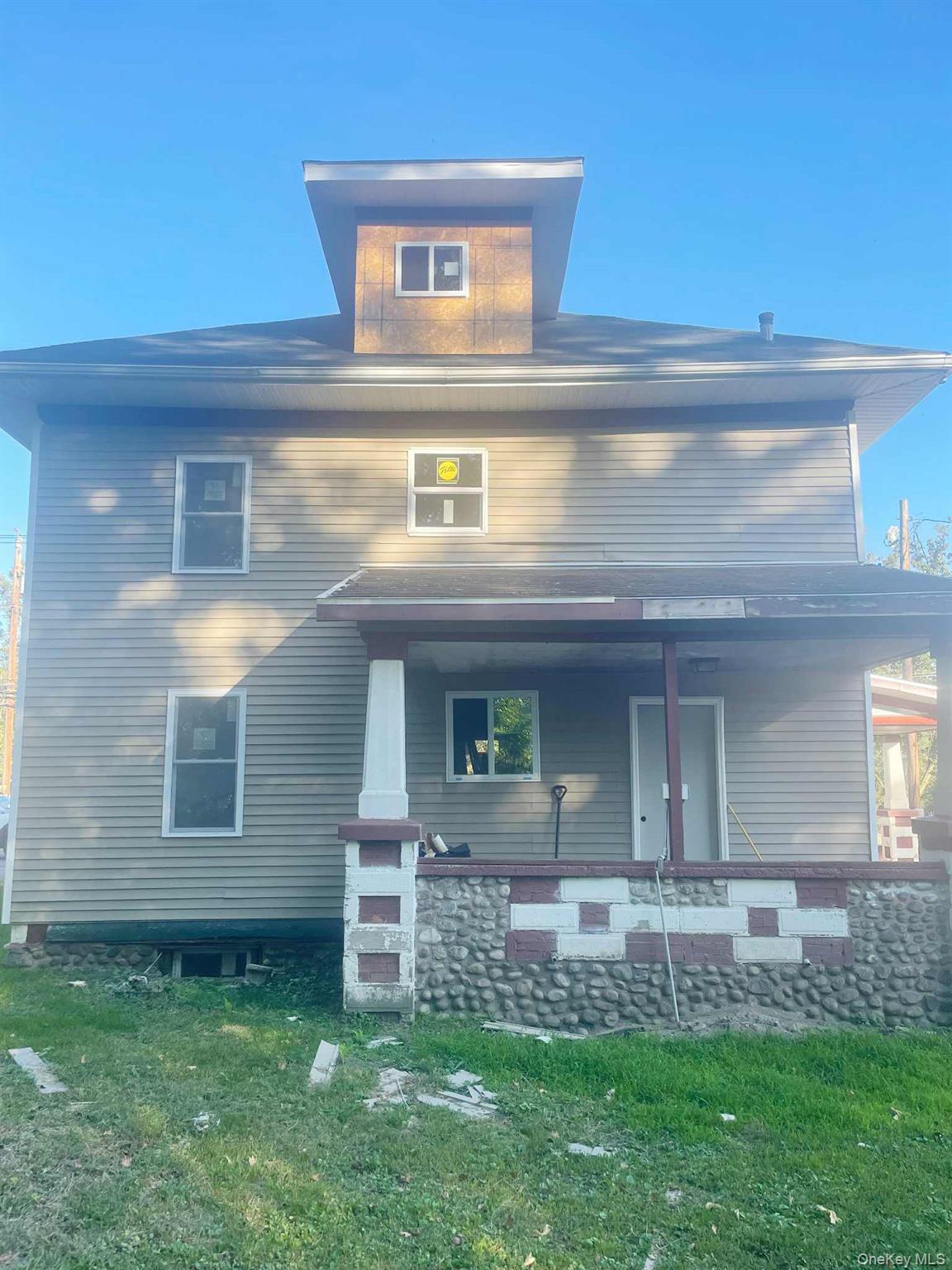 189 East Main Street Port Jervis, NY 12771 - Photo 2 of 5 View of front of house featuring a front yard and covered porch