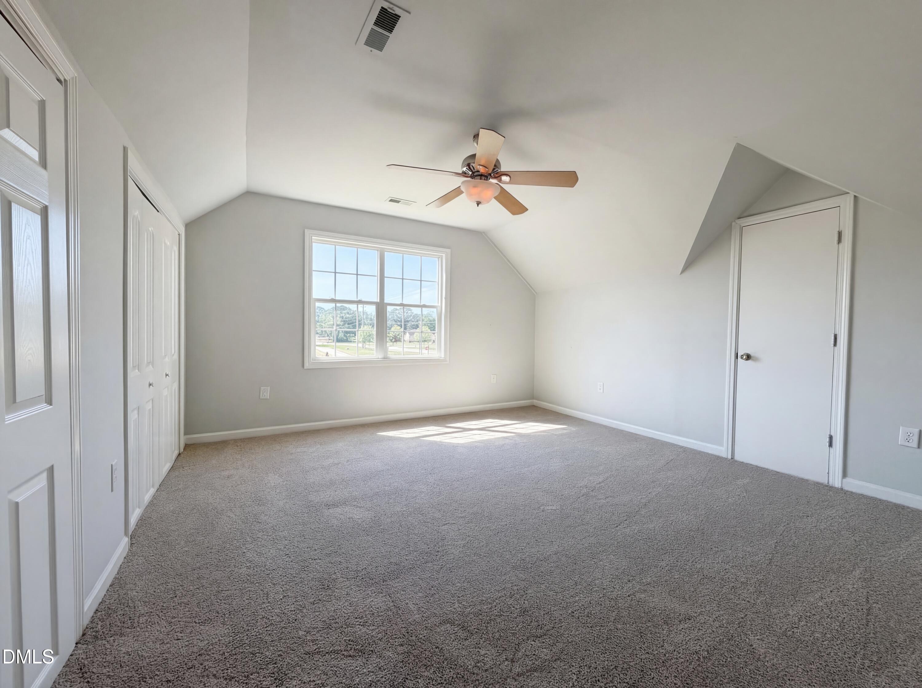 1071 Darius Pearce Road Youngsville, NC 27596 - Photo 11 of 22 an empty room with a window and a ceiling fan