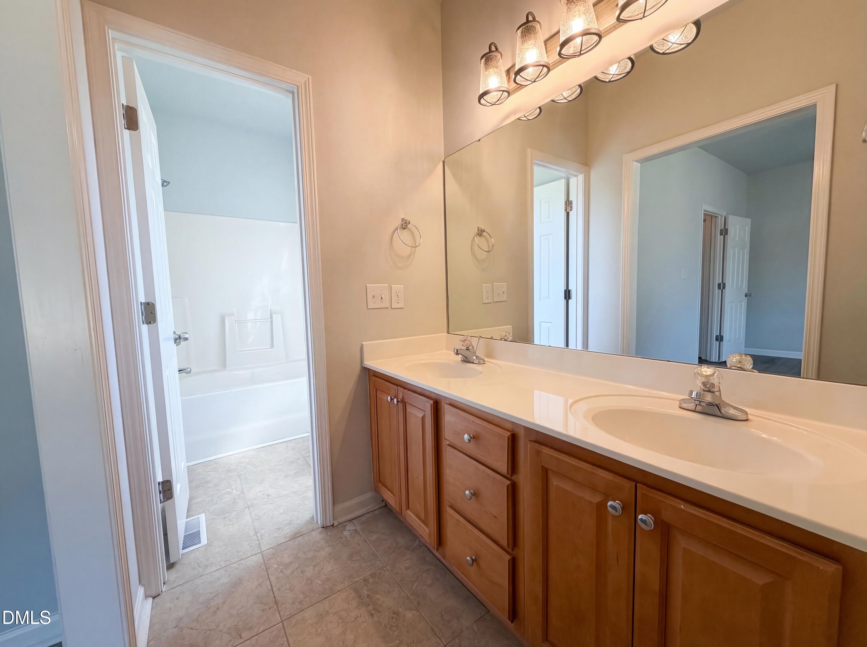 1071 Darius Pearce Road Youngsville, NC 27596 - Photo 12 of 22 a spacious bathroom with a double vanity sink mirror and double