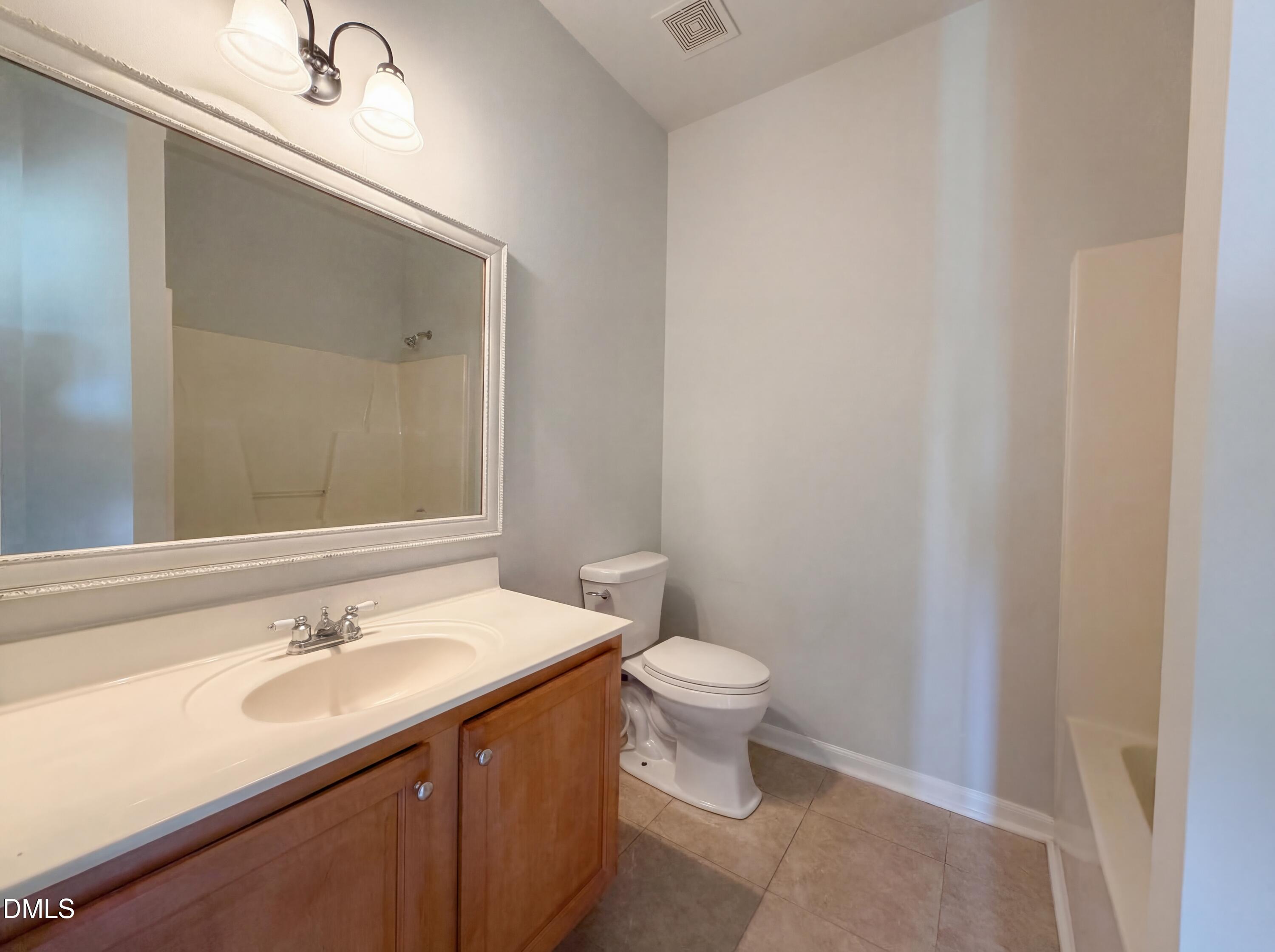 1071 Darius Pearce Road Youngsville, NC 27596 - Photo 13 of 22 a bathroom with a sink and a mirror