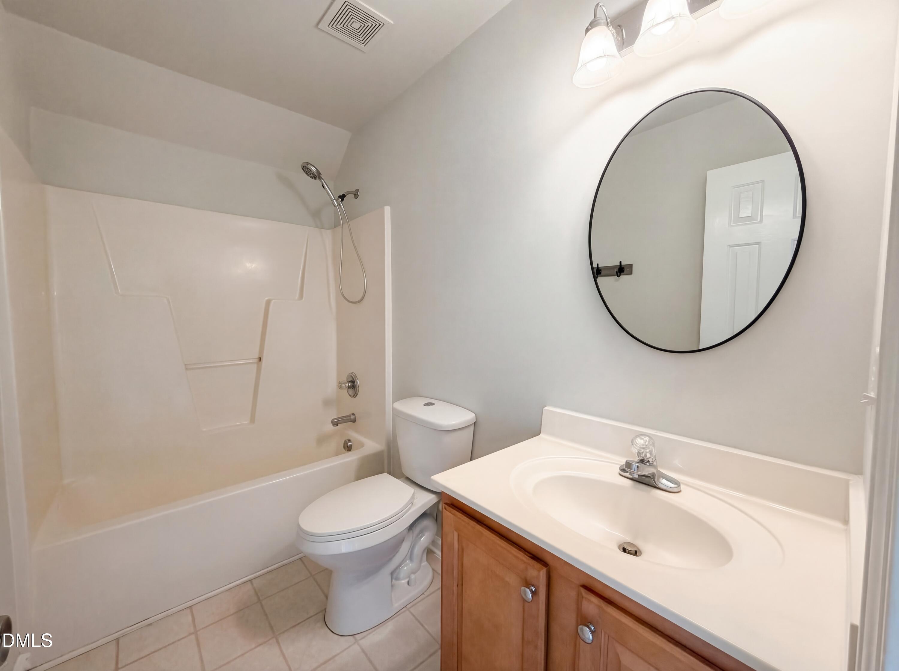 1071 Darius Pearce Road Youngsville, NC 27596 - Photo 14 of 22 a bathroom with a sink a toilet and a mirror
