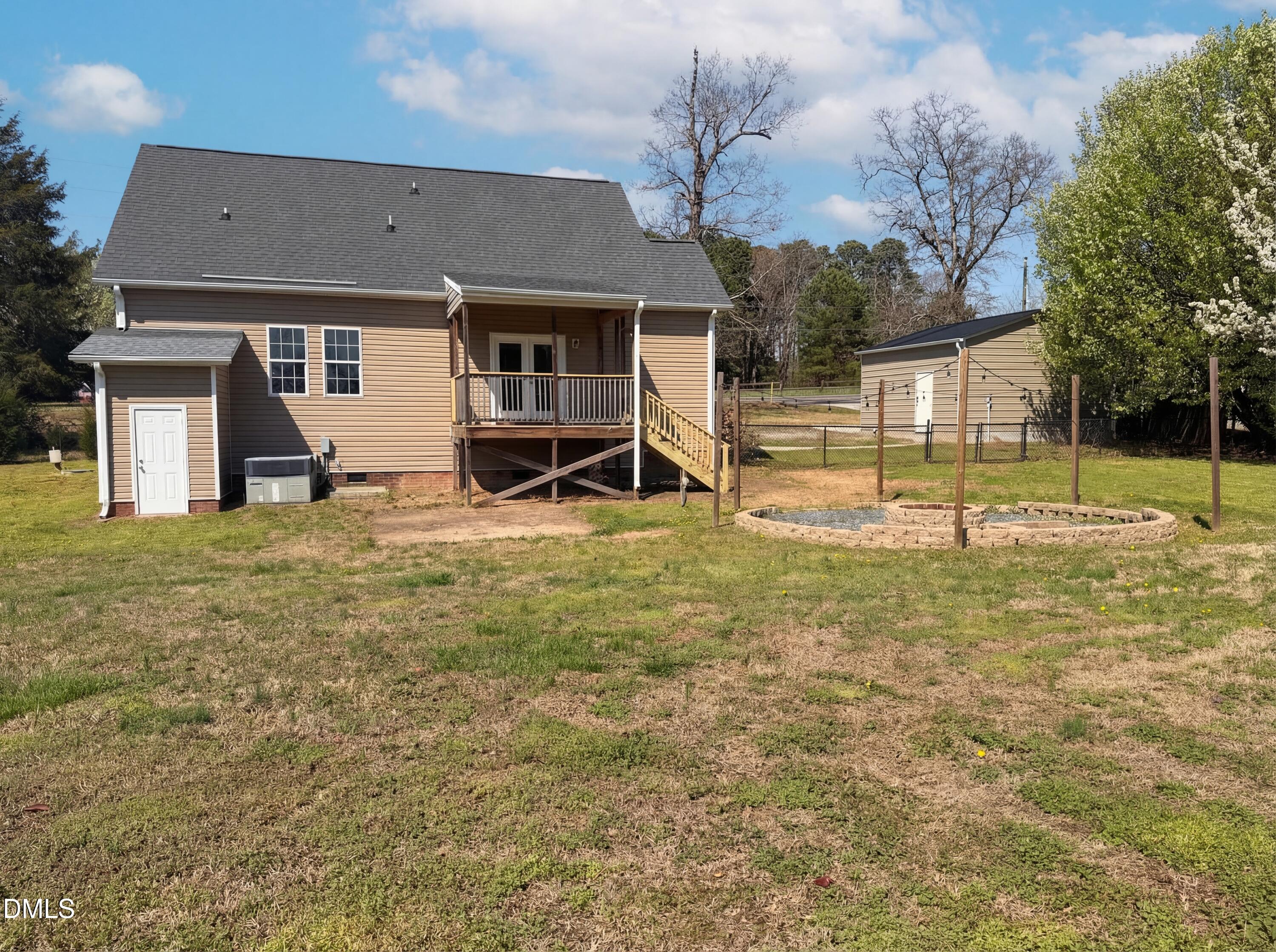 1071 Darius Pearce Road Youngsville, NC 27596 - Photo 20 of 22 a view of a house with backyard and a tree