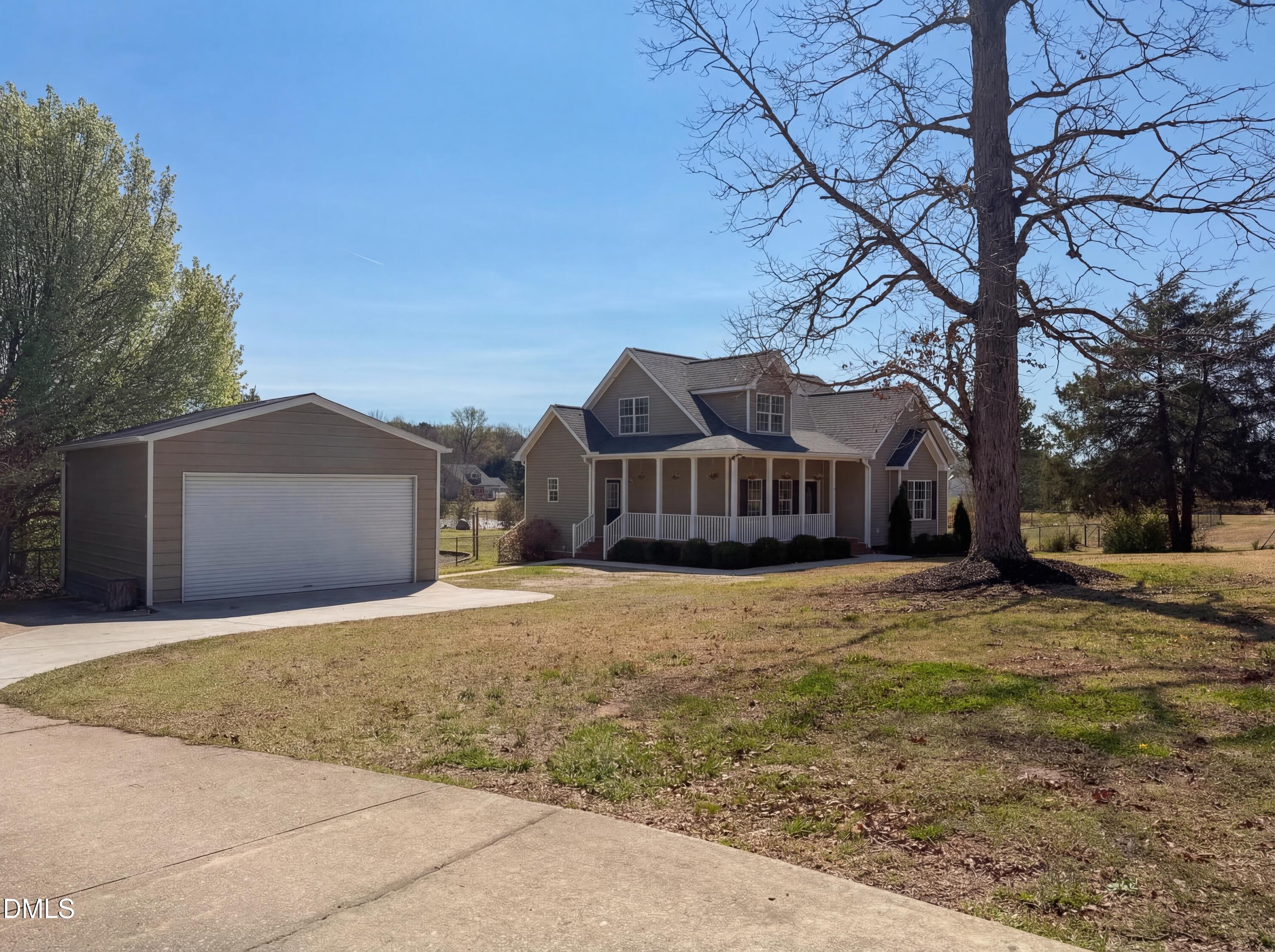 1071 Darius Pearce Road Youngsville, NC 27596 - Photo 2 of 22 a front view of a house with a yard and garage