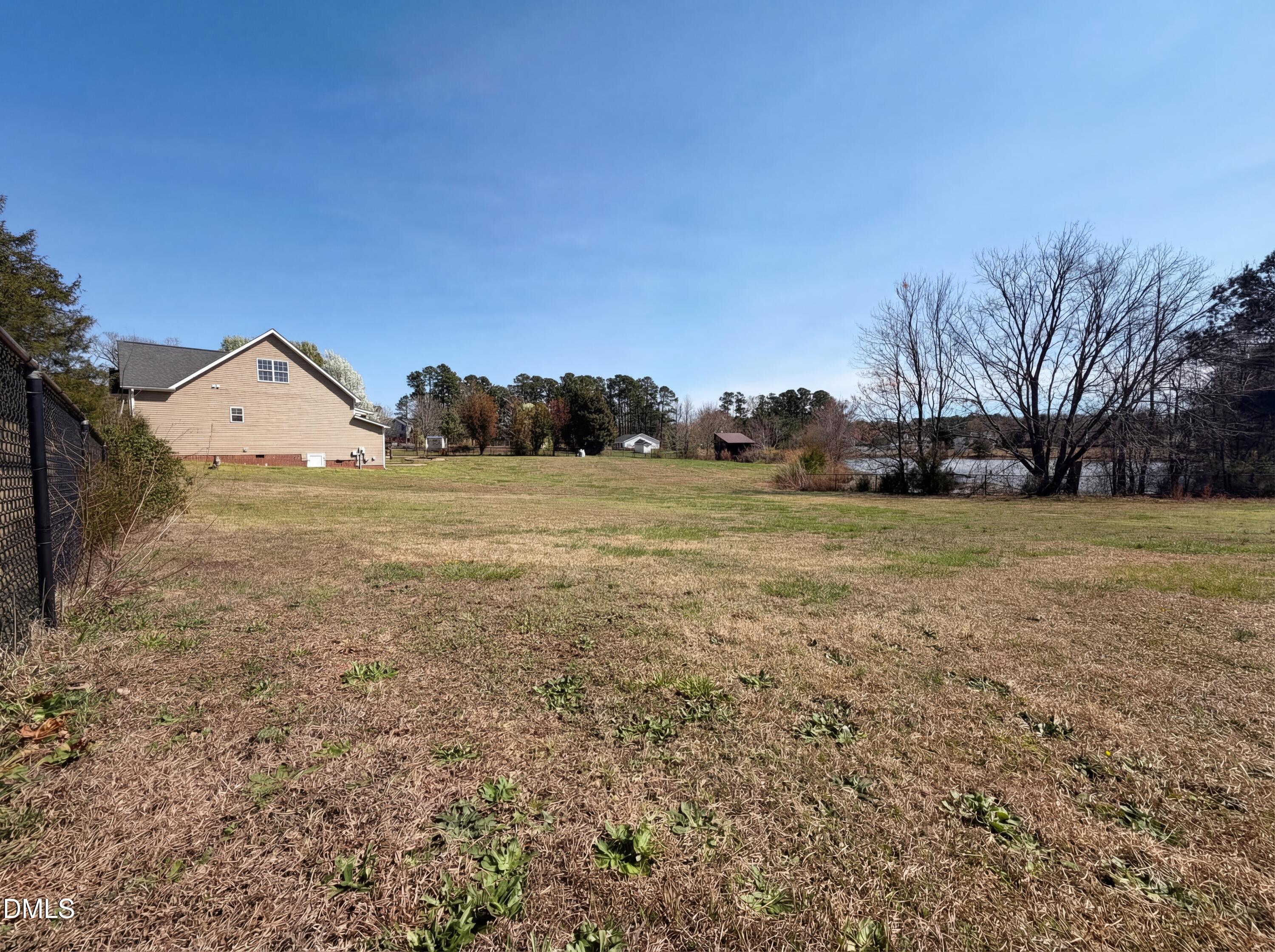 1071 Darius Pearce Road Youngsville, NC 27596 - Photo 21 of 22 a view of a field with an trees in front of it