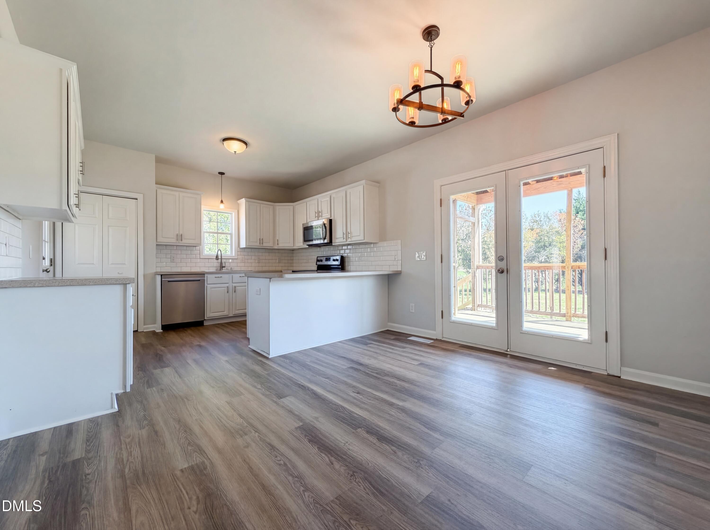 1071 Darius Pearce Road Youngsville, NC 27596 - Photo 5 of 22 a view of a kitchen with a sink dishwasher cabinets and a kitchen