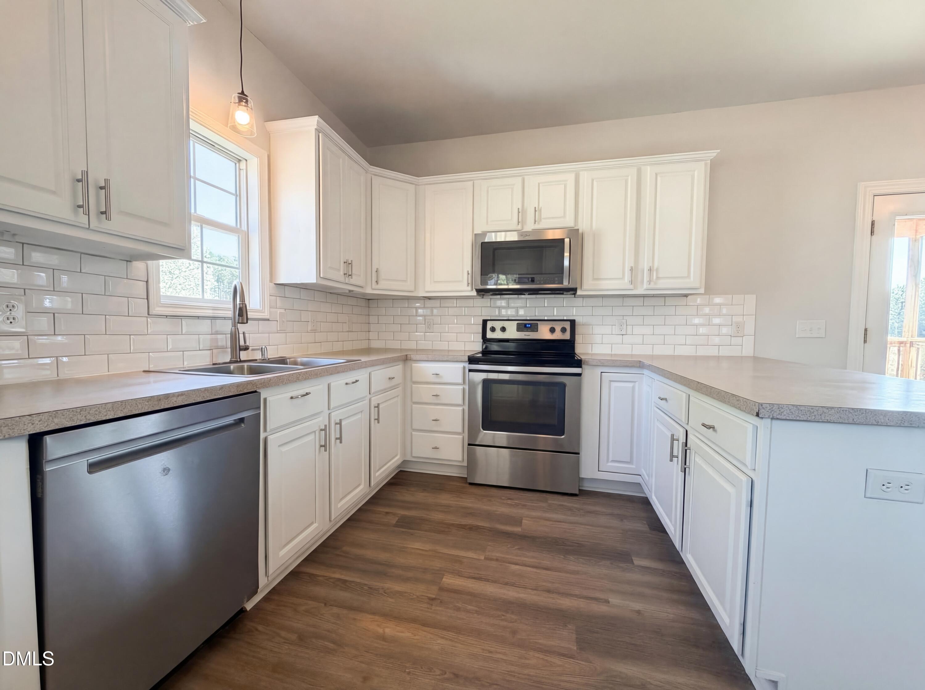 1071 Darius Pearce Road Youngsville, NC 27596 - Photo 6 of 22 a kitchen with stainless steel appliances a white stove top oven and sink
