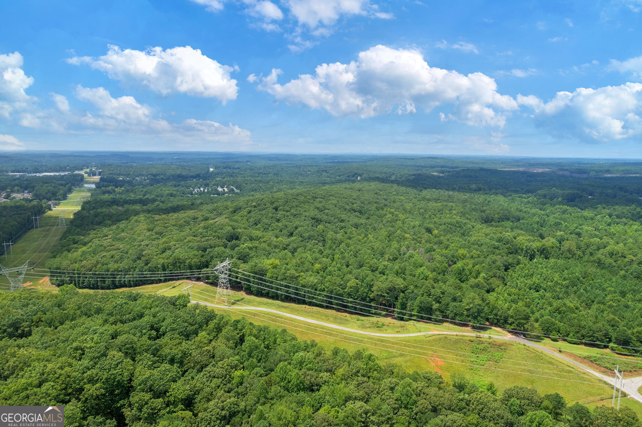7201 Browns Mill Road Lithonia, GA 30038 - Photo 20 of 29 a view of a big yard with lots of green space and mountain view in back