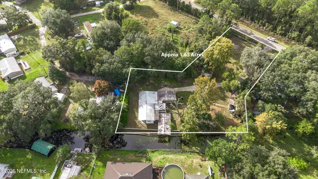 a backyard of a house with lots of green space and plants