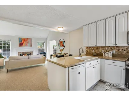a view of a kitchen area with sink dining table and chairs