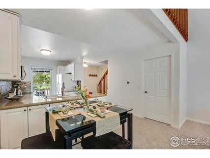 a kitchen with granite countertop a sink a stove and cabinets