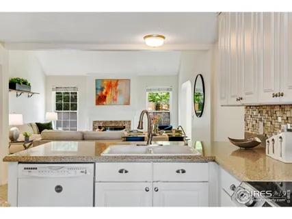 a kitchen with granite countertop a sink a stove and microwave
