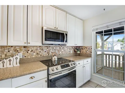 a living room with furniture a rug and a chandelier