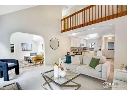 a living room with furniture a rug and a chandelier