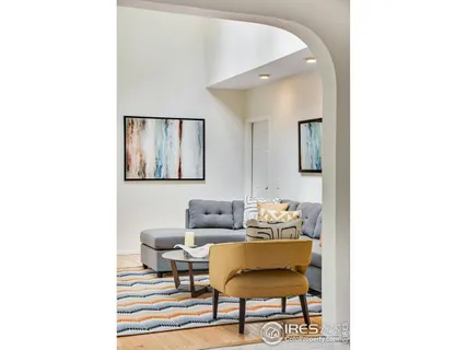 a living room with furniture ceiling fan and a window