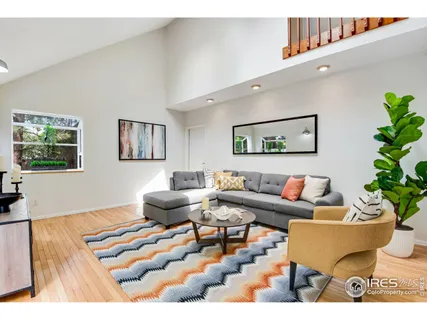 a living room with furniture and flowers