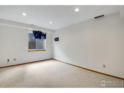 a view of an empty room with a painting on the wall