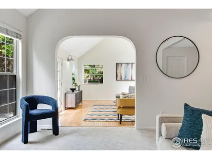 a living room with furniture and a mirror