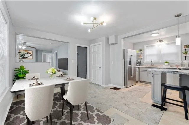 a living room with kitchen island furniture and a chandelier