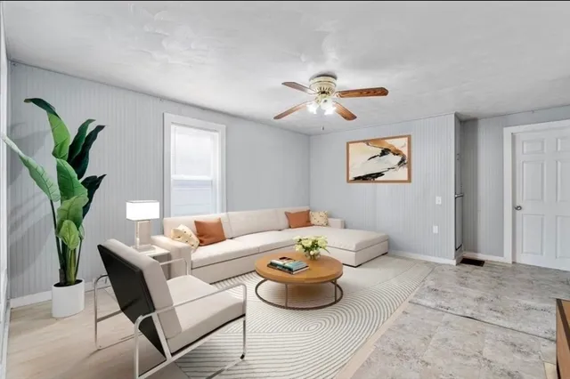 a living room with furniture and a potted plant