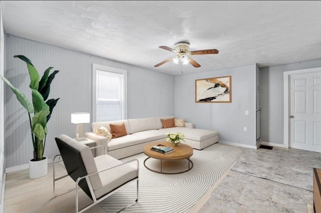 320 Cedar Street, Unit 1 Manchester, NH 03103 - Photo 2 of 4 a living room with furniture and a potted plant