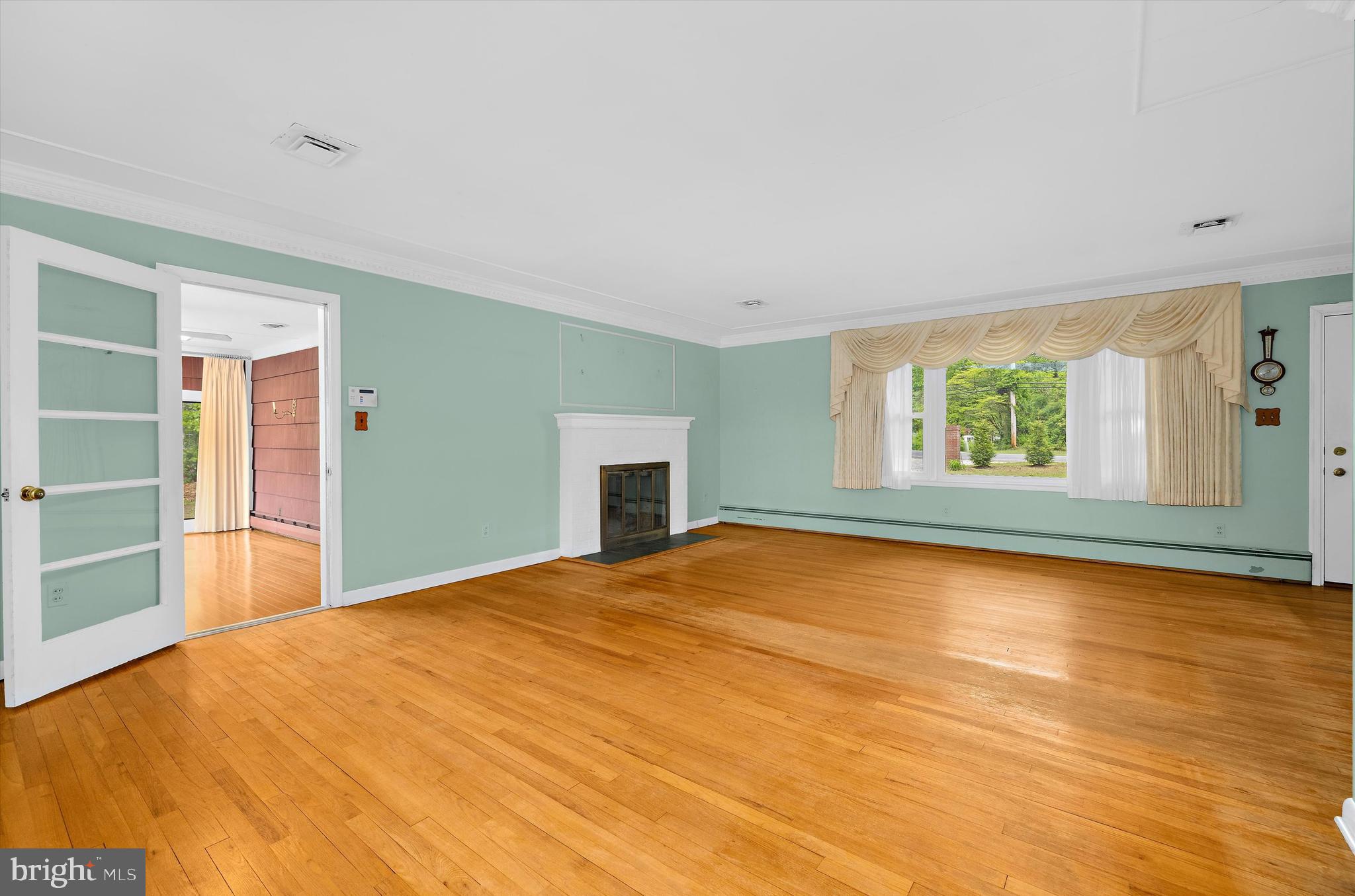 1159 Dicus Mill Road Millersville, MD 21108 - Photo 12 of 81 a view of an empty room with window and wooden floor