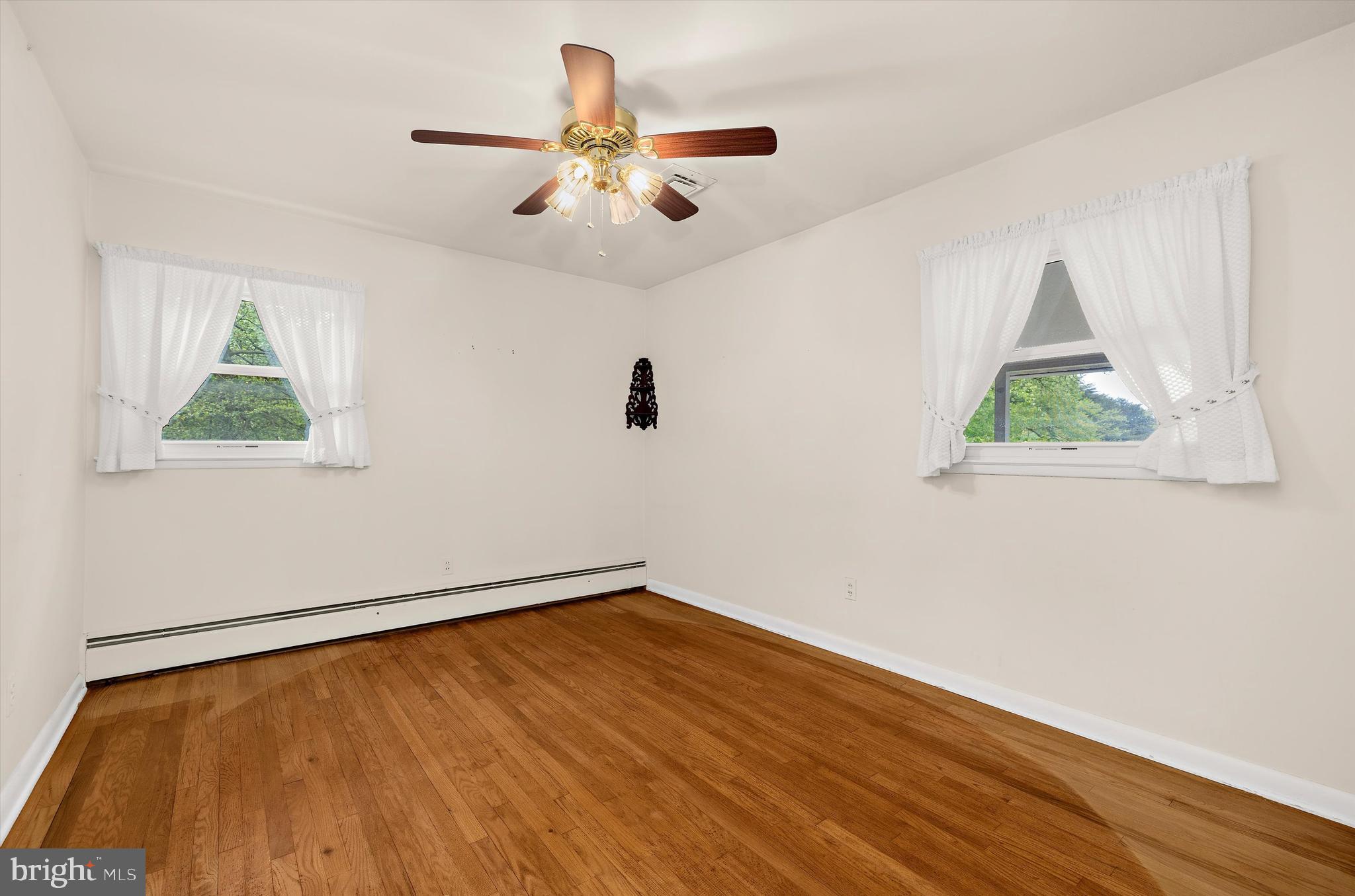 1159 Dicus Mill Road Millersville, MD 21108 - Photo 23 of 81 a view of an empty room with wooden floor and a window