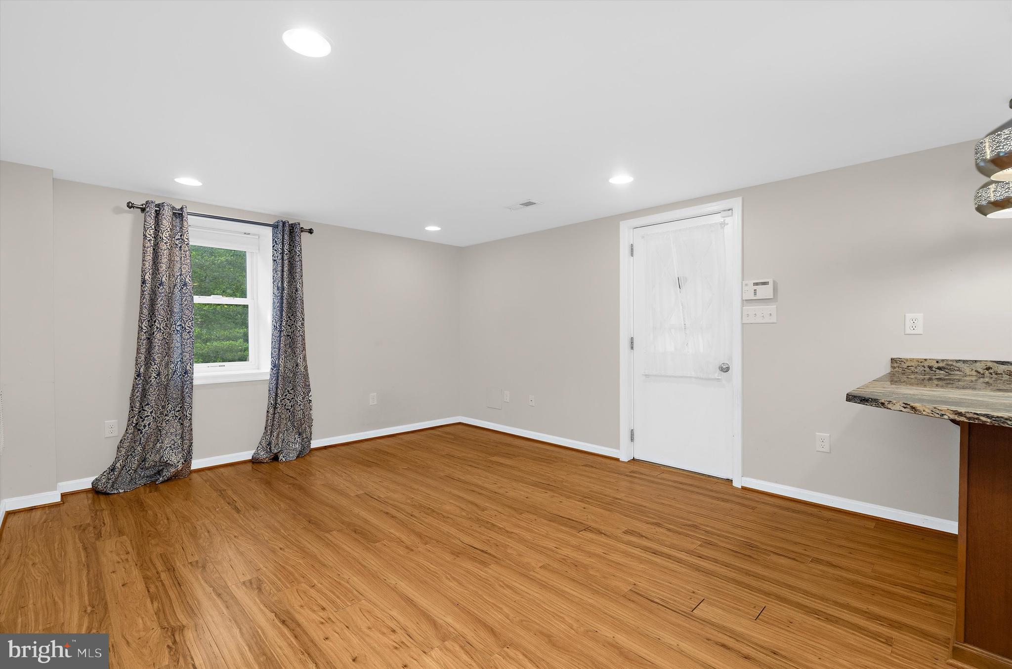 1159 Dicus Mill Road Millersville, MD 21108 - Photo 29 of 81 a view of an empty room with wooden floor and a window