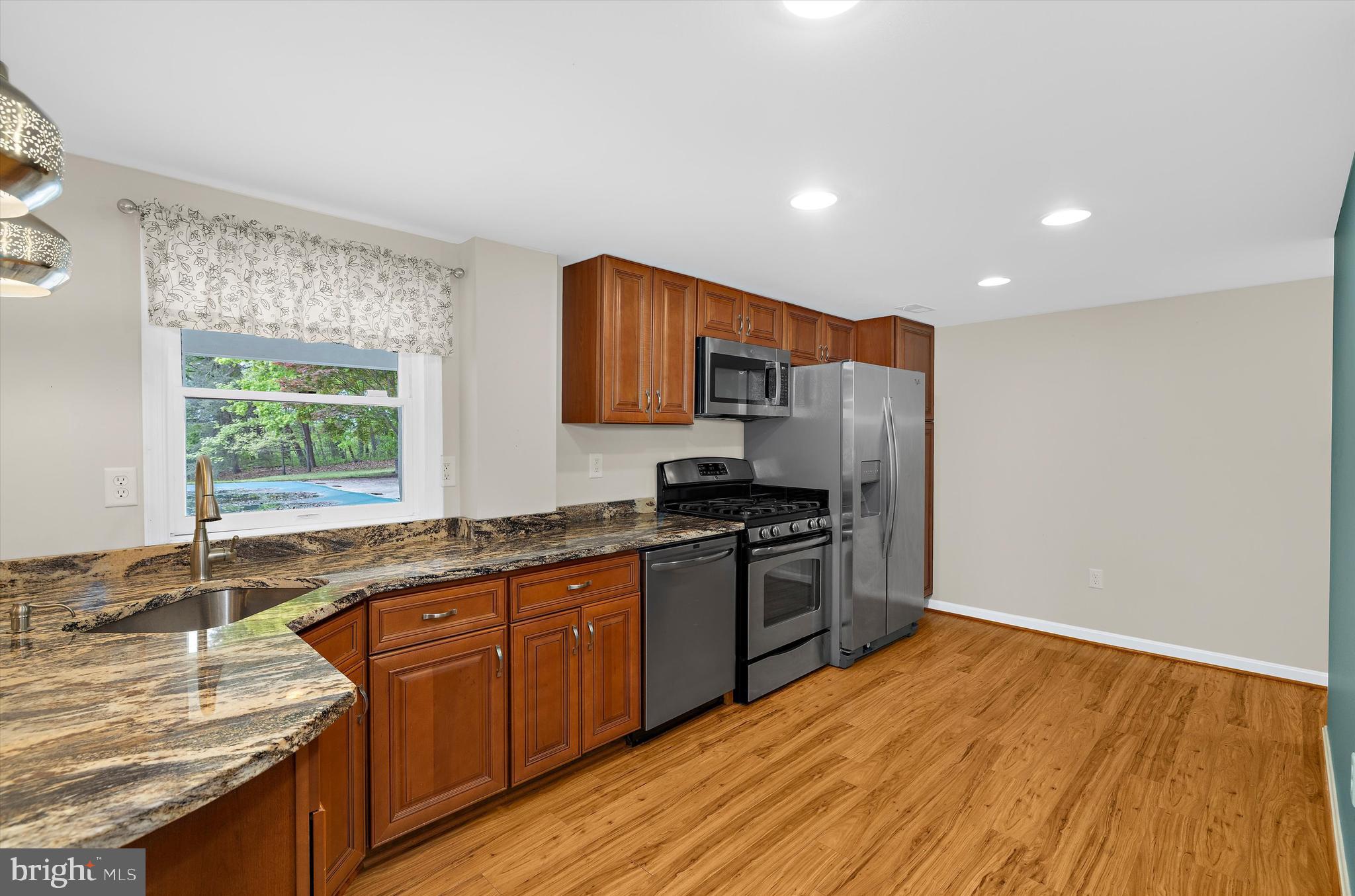 1159 Dicus Mill Road Millersville, MD 21108 - Photo 35 of 81 a kitchen with stainless steel appliances granite countertop a sink stove and refrigerator
