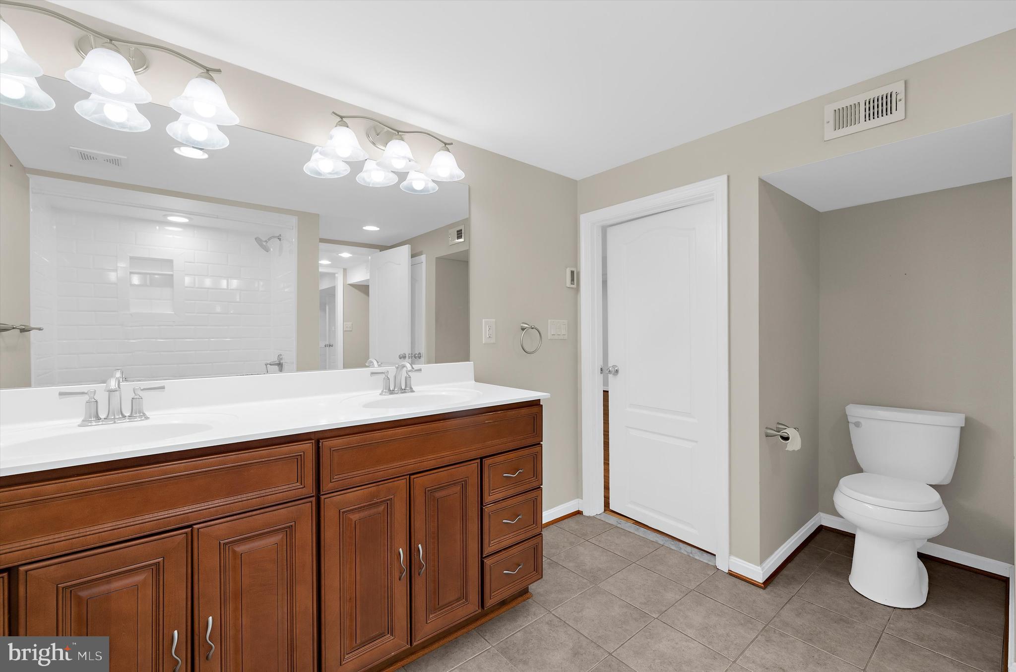 1159 Dicus Mill Road Millersville, MD 21108 - Photo 44 of 81 a bathroom with a toilet sink and mirror