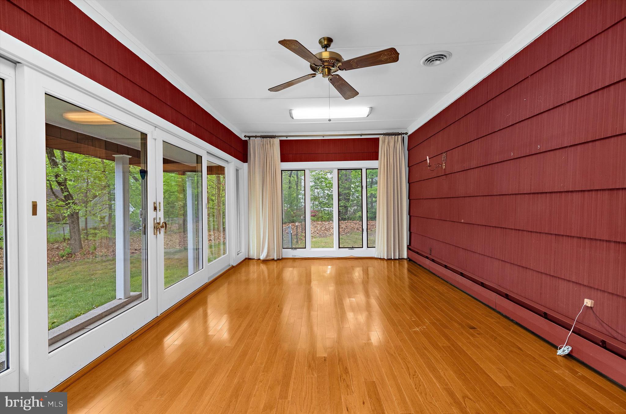 1159 Dicus Mill Road Millersville, MD 21108 - Photo 47 of 81 a view of an empty room with wooden floor and a ceiling fan