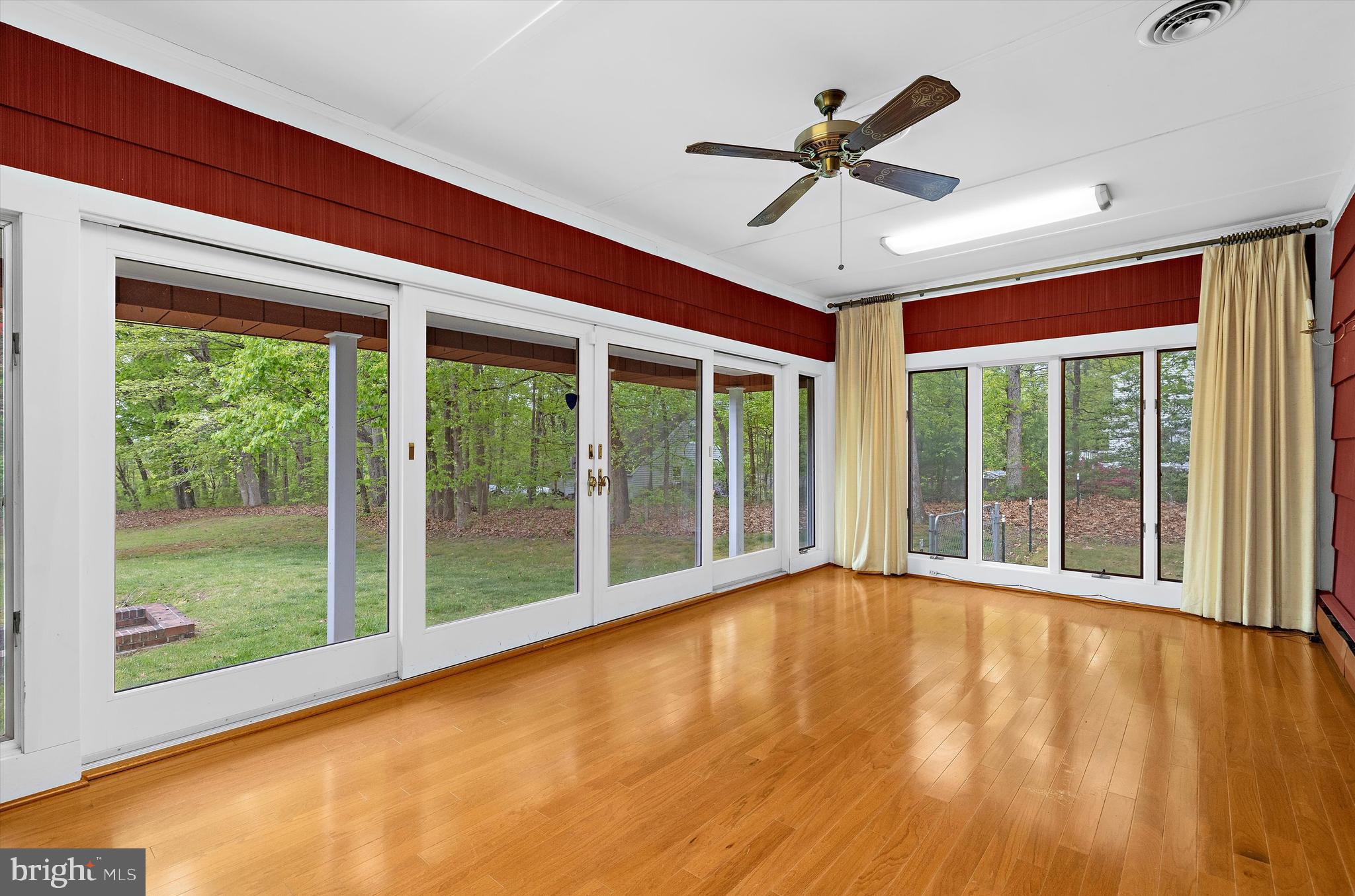 1159 Dicus Mill Road Millersville, MD 21108 - Photo 48 of 81 a view of an empty room with a window and wooden floor