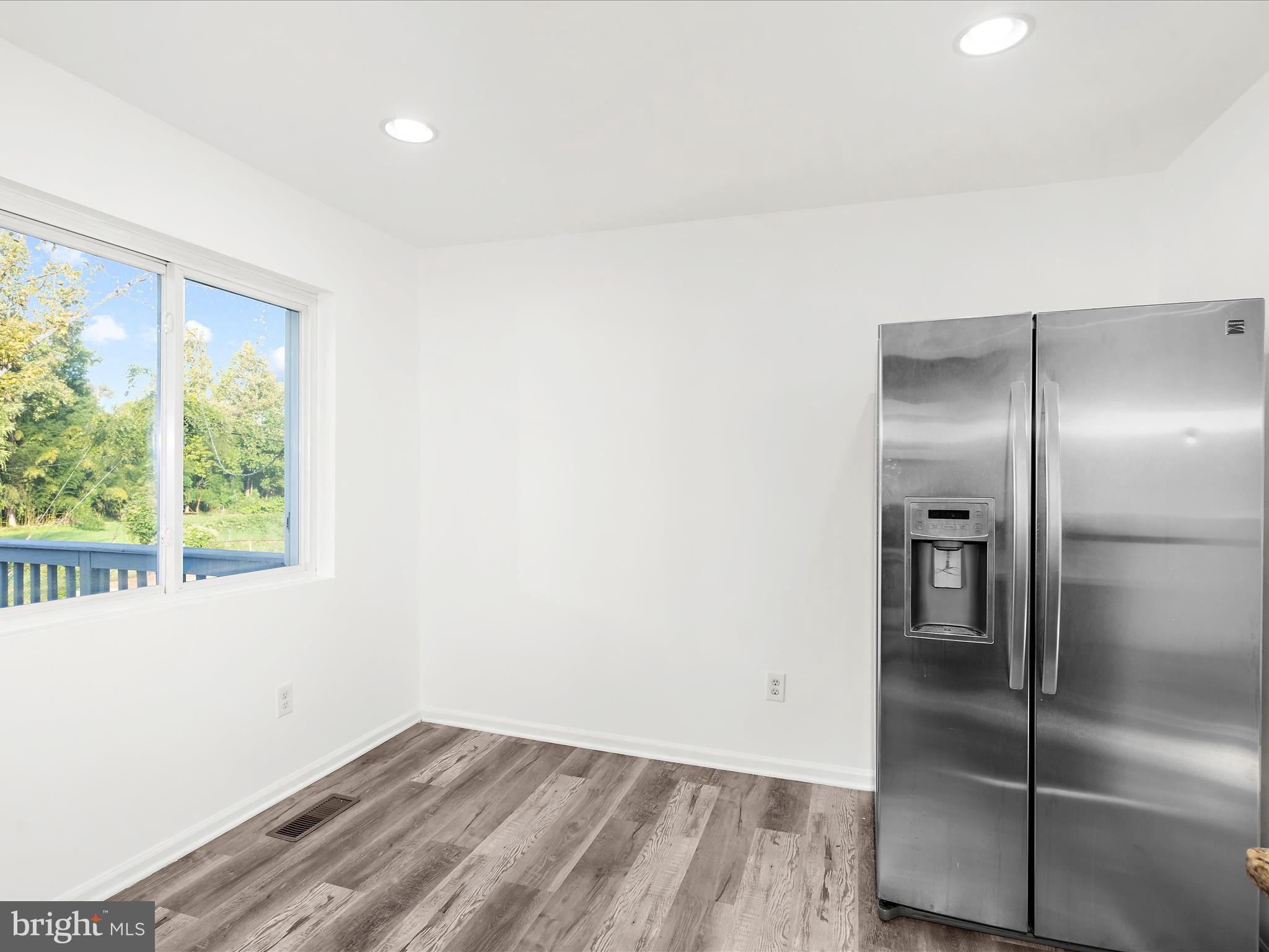 400 Dale Avenue Baltimore, MD 21206 - Photo 12 of 27 a view of an empty room with wooden floor and a window
